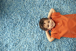 Boy Lying on Carpet